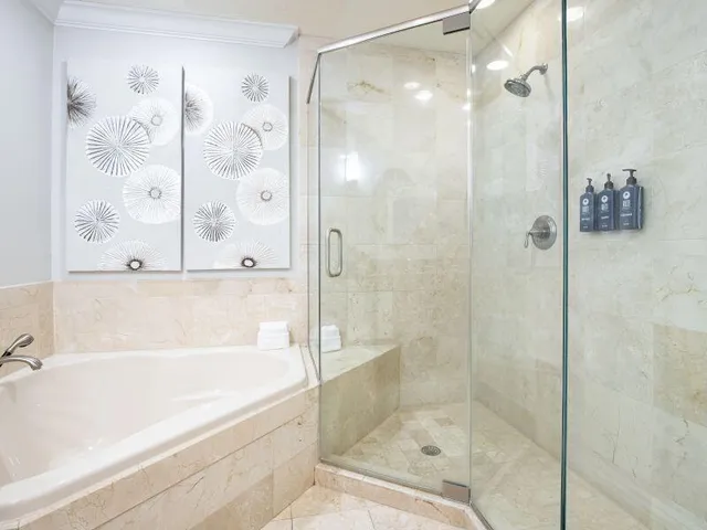 a bathroom with a shower and a bath tub
