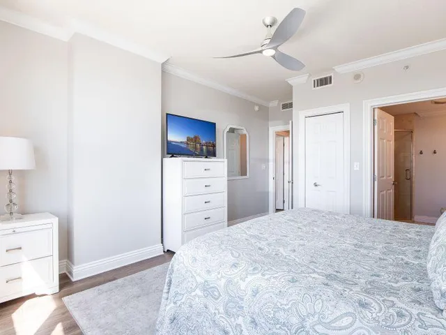 a large bedroom with a bed and cabinets