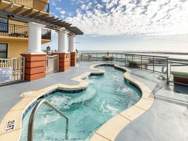 a view of a swimming pool with outdoor seating