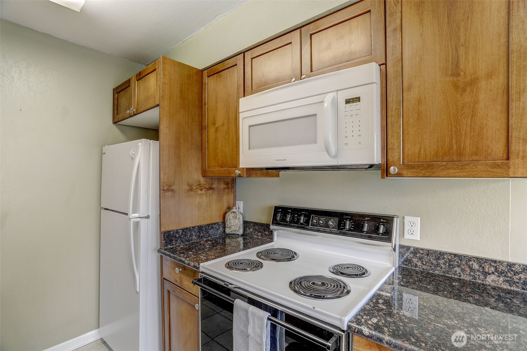 403 East Thomas Street, Unit 19 Seattle, WA 98102 - Photo 13 of 24 a kitchen with stainless steel appliances granite countertop a stove and a refrigerator