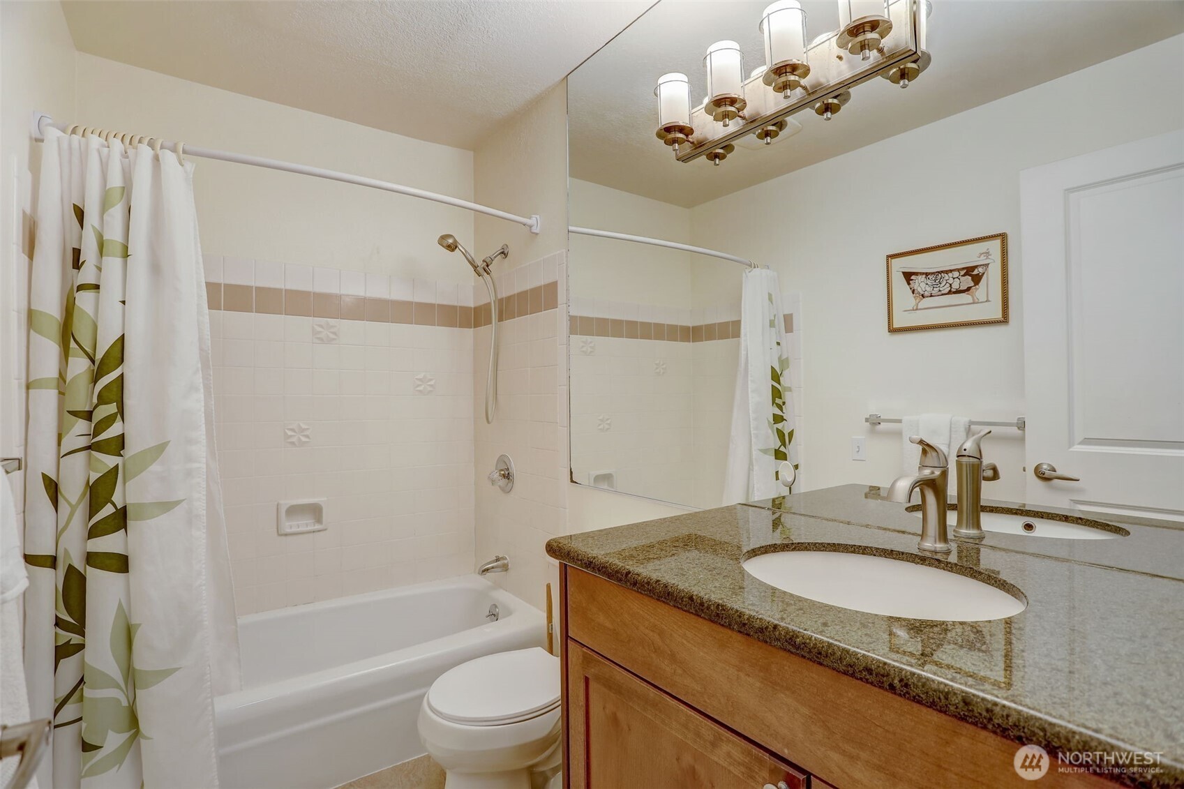 403 East Thomas Street, Unit 19 Seattle, WA 98102 - Photo 16 of 24 a bathroom with a granite countertop shower a sink and a mirror