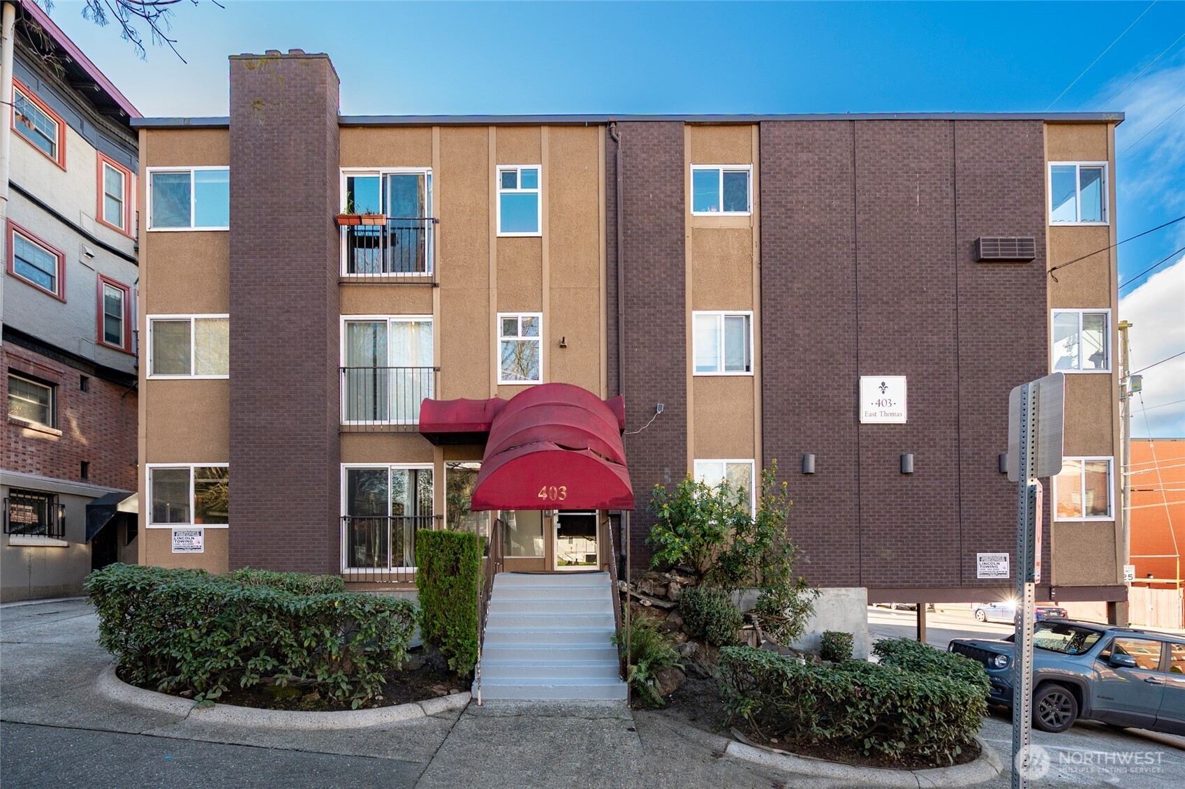 403 East Thomas Street, Unit 19 Seattle, WA 98102 - Photo 3 of 24 a front view of a residential apartment building with a yard