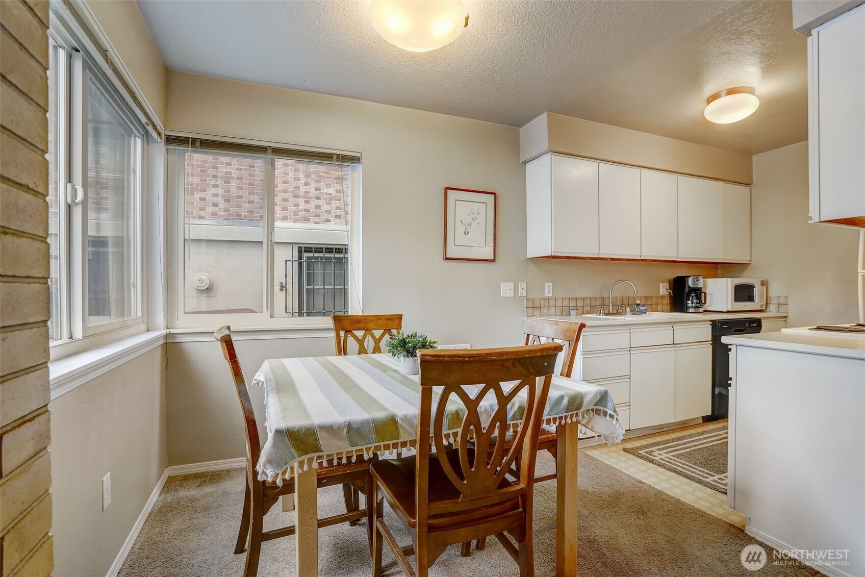 403 East Thomas Street, Unit 19 Seattle, WA 98102 - Photo 8 of 24 a view of a dining room with furniture and wooden floor