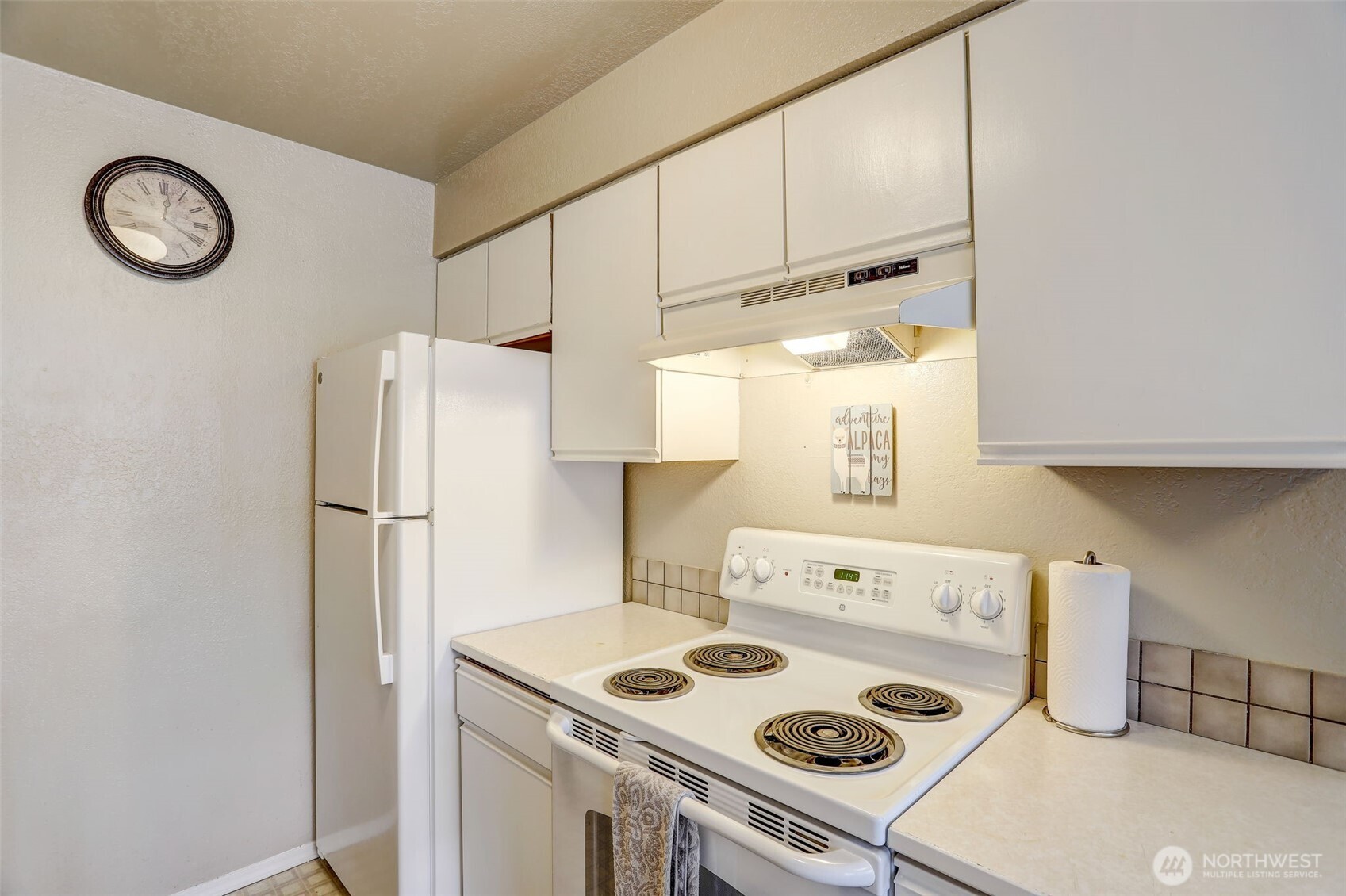 403 East Thomas Street, Unit 19 Seattle, WA 98102 - Photo 10 of 24 a white kitchen with a stove and a refrigerator