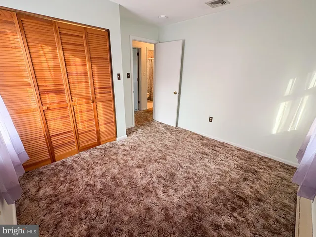 a view of room with window and a bathroom