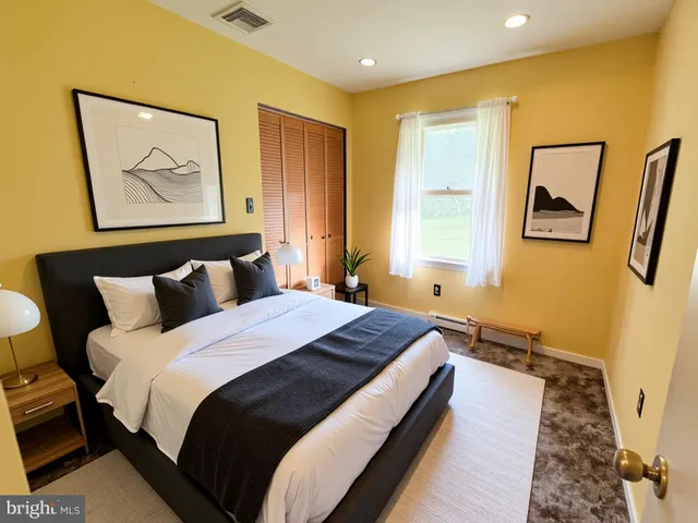 a bedroom with bed and window