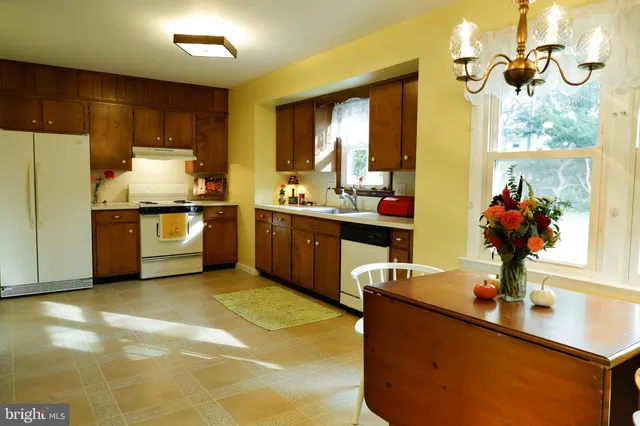 a kitchen with stainless steel appliances granite countertop a sink and a stove