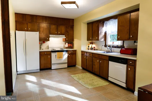 a kitchen with stainless steel appliances a sink and cabinets
