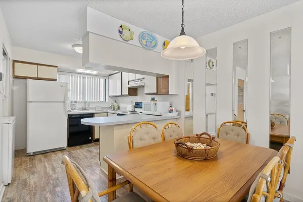 a living room with kitchen island furniture and a table