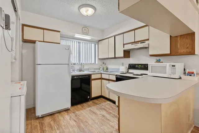 a kitchen with stainless steel appliances a refrigerator stove and sink