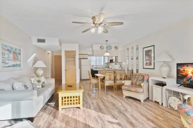 a spacious bedroom with a bed and a flat screen tv