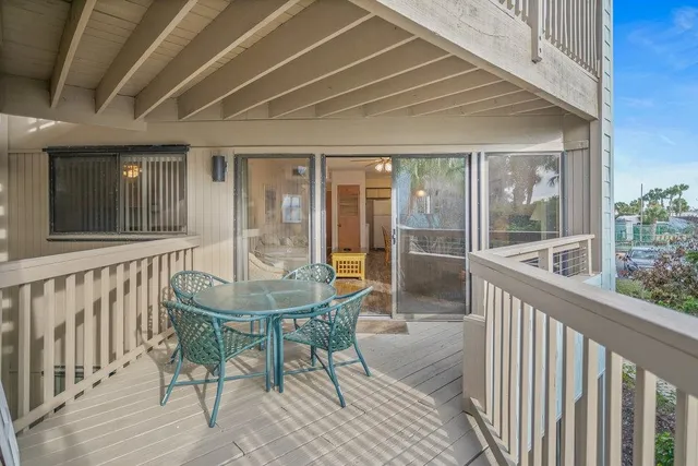 a view of balcony with wooden floor and fence