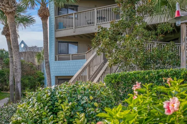 a view of a house with a flower garden