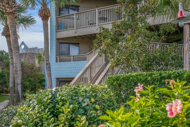 a view of a house with a flower garden