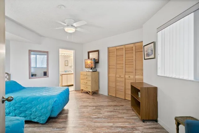 a bedroom with two beds and painting on the wall