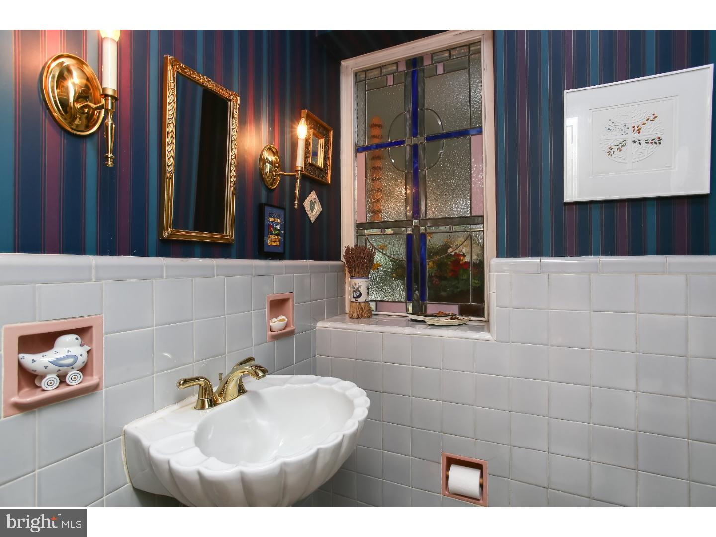114 Stratford Road Wallingford, PA 19086 - Photo 14 of 25 a bathroom with a sink and a mirror