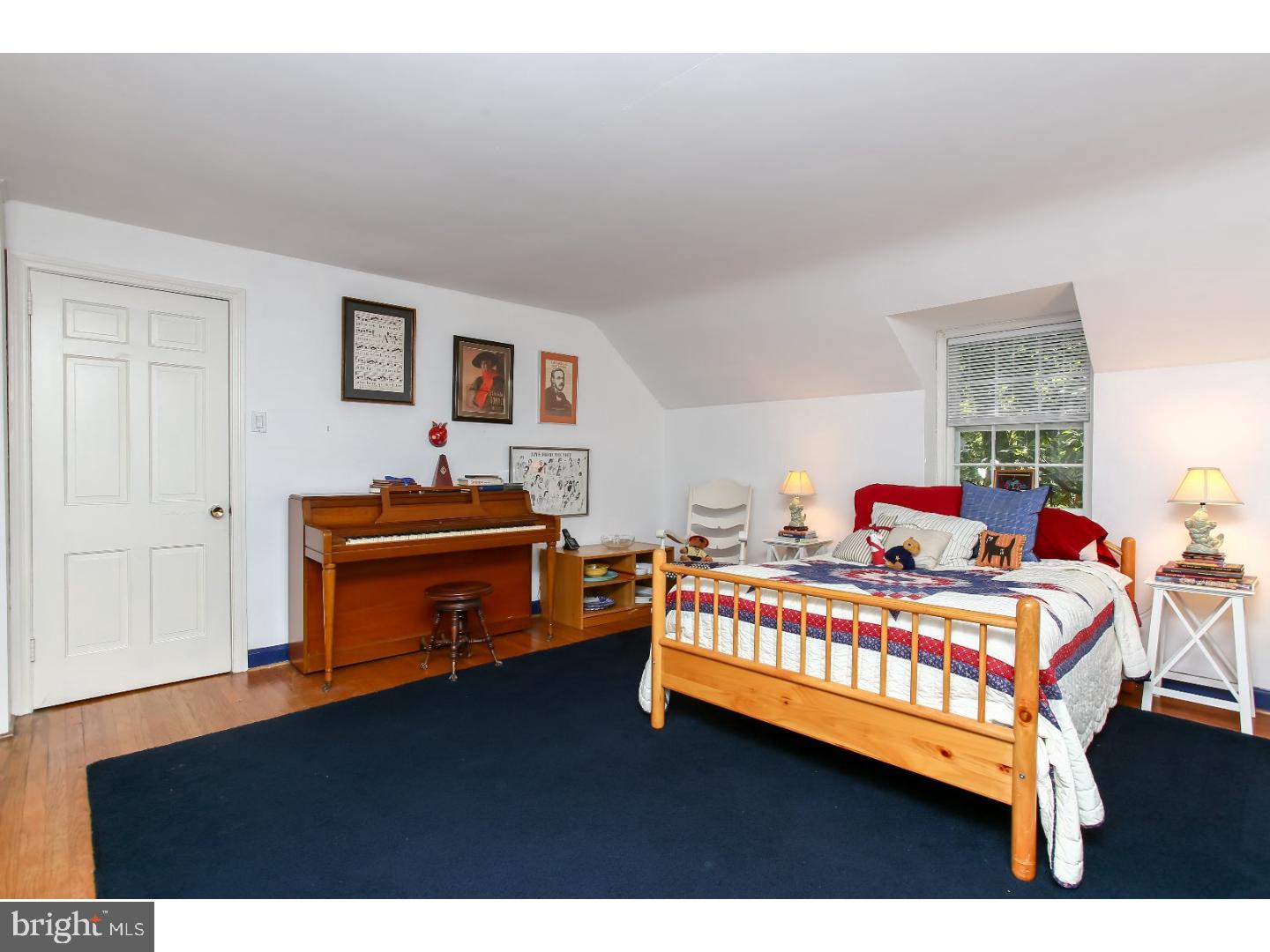 114 Stratford Road Wallingford, PA 19086 - Photo 20 of 25 a bedroom with a bed and a chandelier