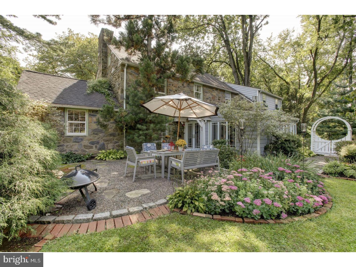 114 Stratford Road Wallingford, PA 19086 - Photo 22 of 25 a view of a house with a chairs and table in a patio