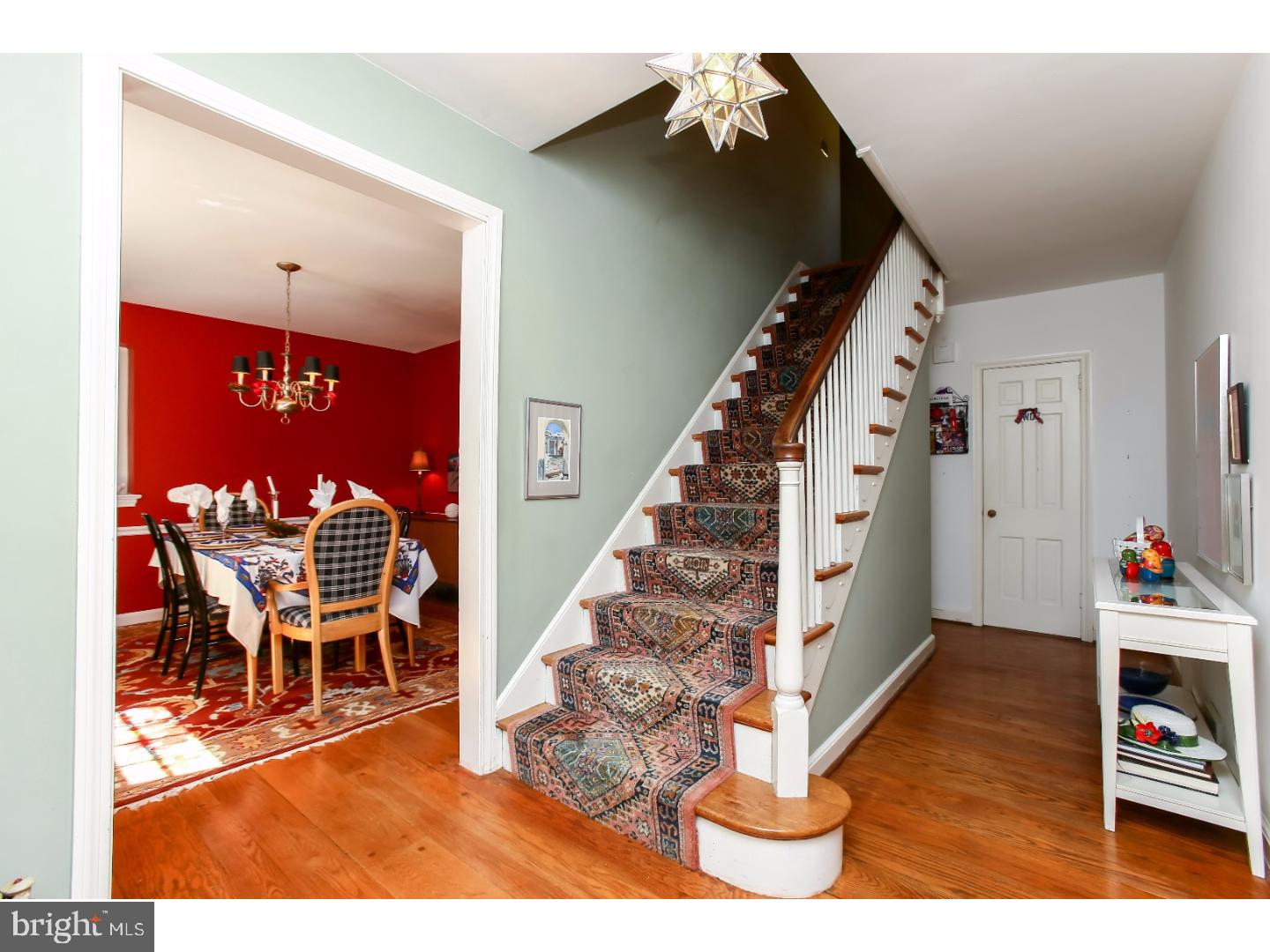 114 Stratford Road Wallingford, PA 19086 - Photo 4 of 25 a view of a hallway with dining room and wooden floor