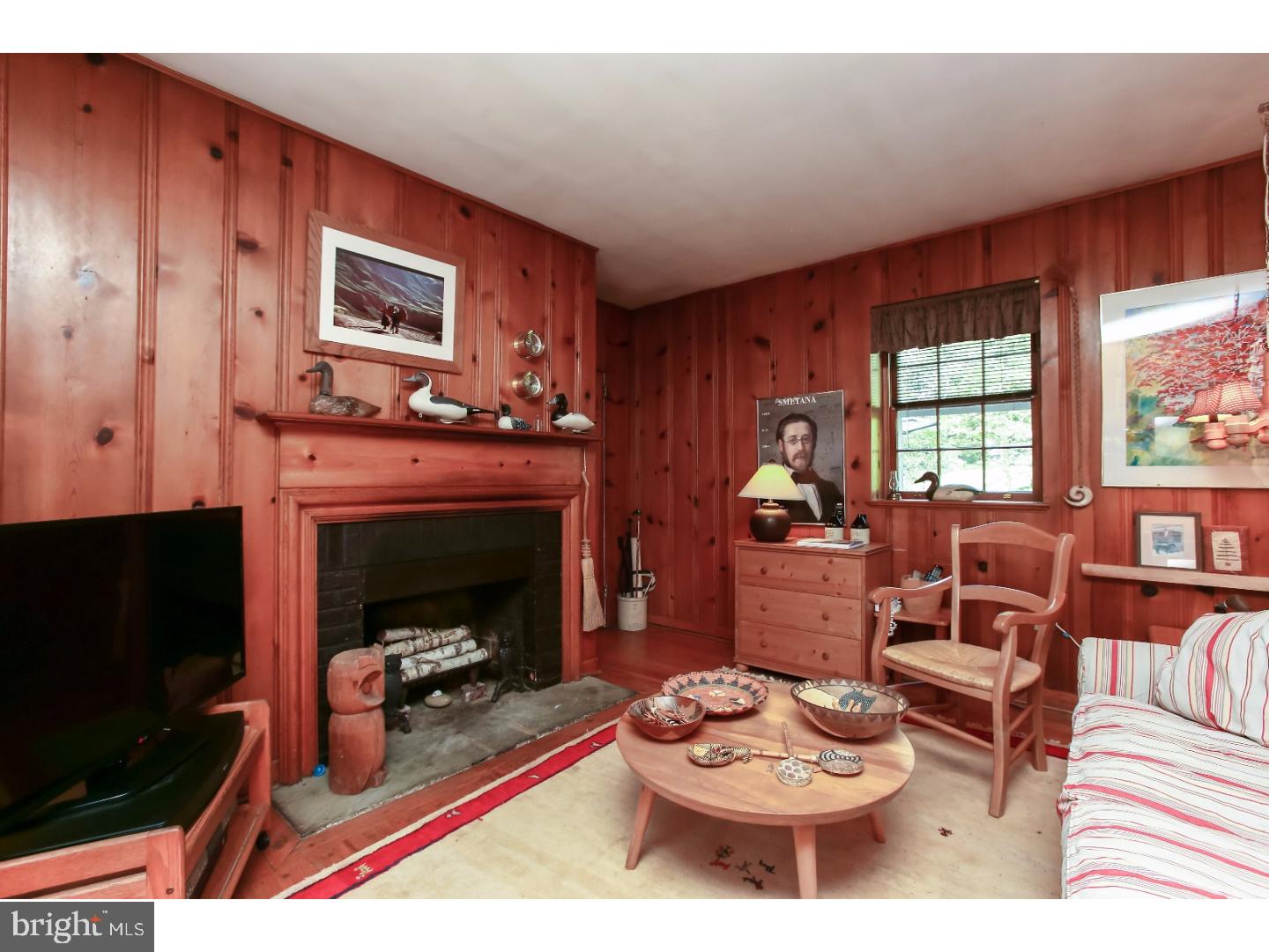 114 Stratford Road Wallingford, PA 19086 - Photo 7 of 25 a living room with furniture and a fireplace