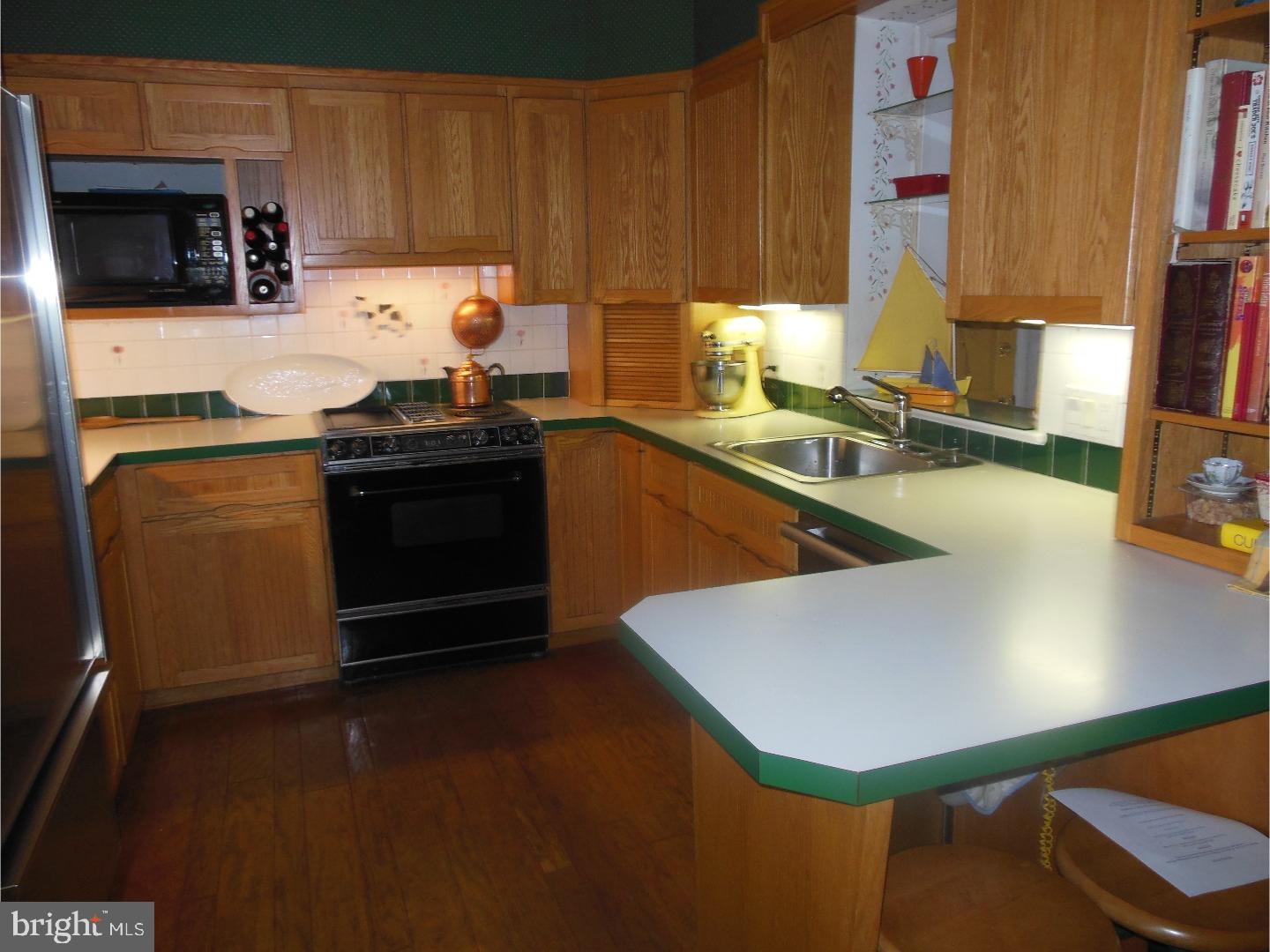 114 Stratford Road Wallingford, PA 19086 - Photo 9 of 25 a kitchen with a sink cabinets and appliances