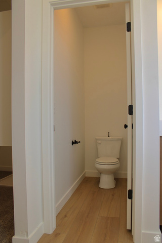 2613 Scarlet Road, Unit 258 Eagle Mountain, UT 84005 - Photo 17 of 32 Powder room featuring light wood-finish flooring, a white toilet, and contrasting dark hardware