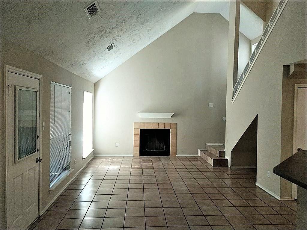 a view of an empty room and a fireplace