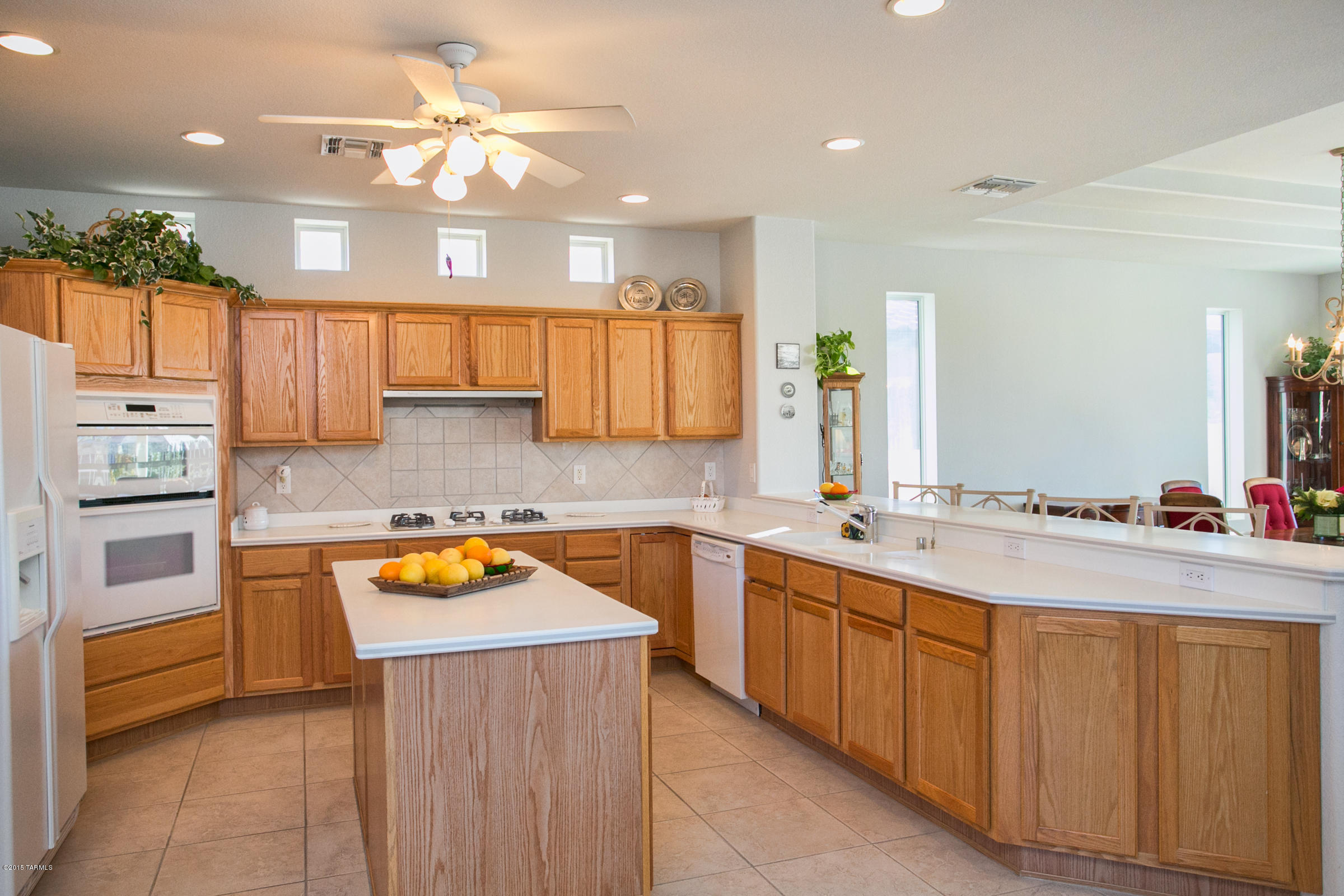 62419 East Northwood Road Tucson, AZ 85739 - Photo 16 of 30 a kitchen with a sink stove and cabinets