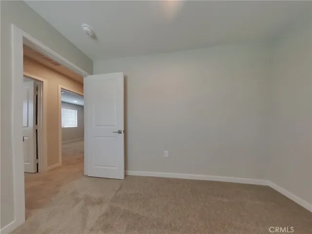 an empty room with closet area