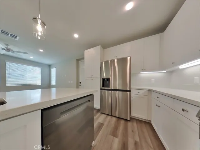 a kitchen with a refrigerator and a sink