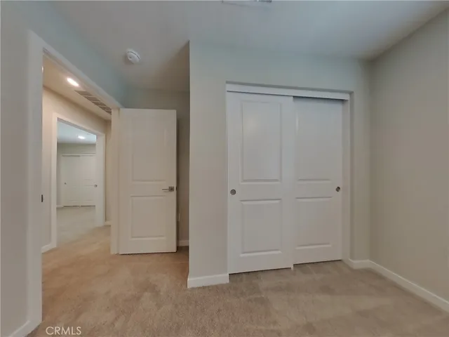 an empty room with closet area