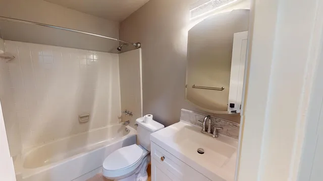 a bathroom with a sink mirror bathtub and toilet
