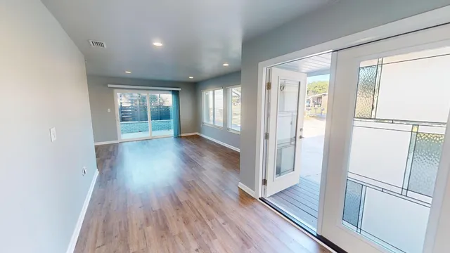 a view of wooden floor and windows in an empty room