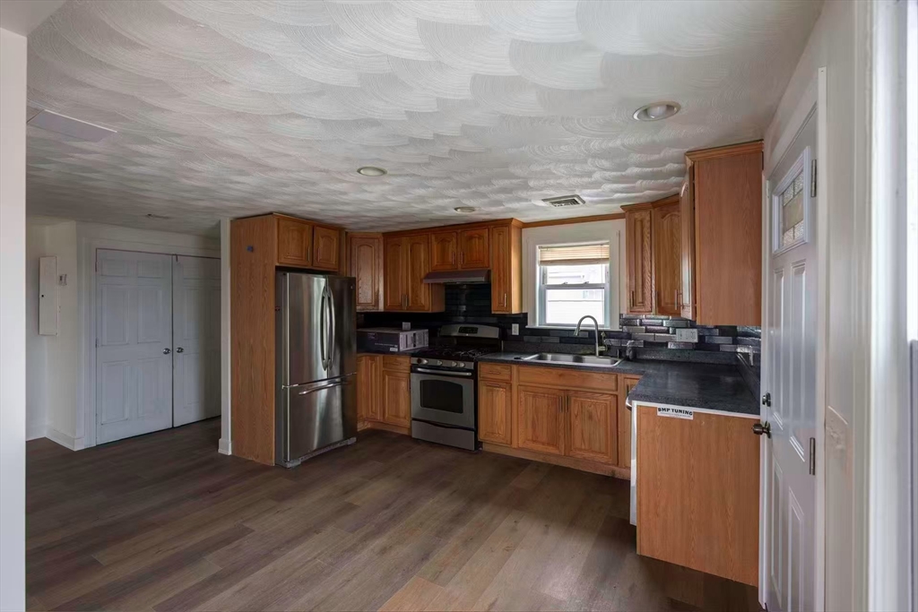 281 Beach Street, Unit 2 Revere, MA 02151 - Photo 12 of 17 a kitchen with stainless steel appliances granite countertop a stove and a refrigerator