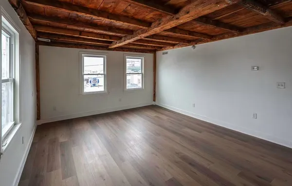 a view of a room with wooden floors and roof