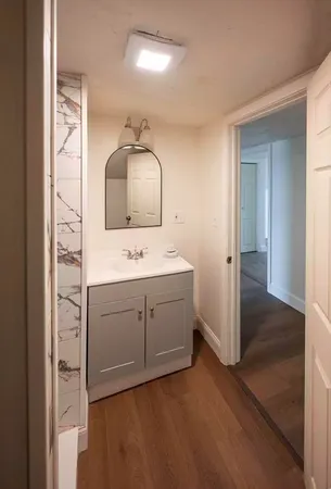 a bathroom with a sink vanity and mirror