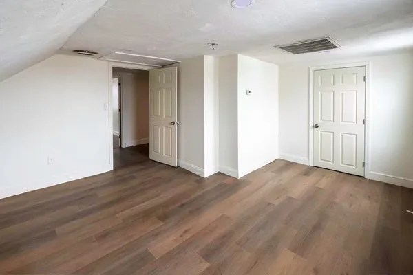 a view of a room with wooden floor and bathroom