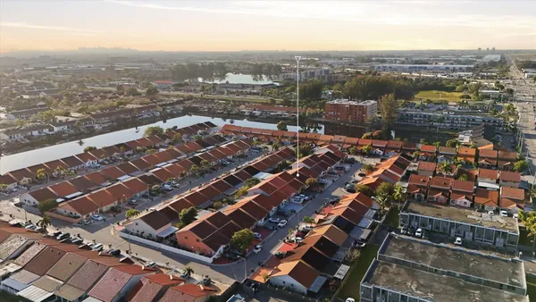 an aerial view of residential houses with outdoor space