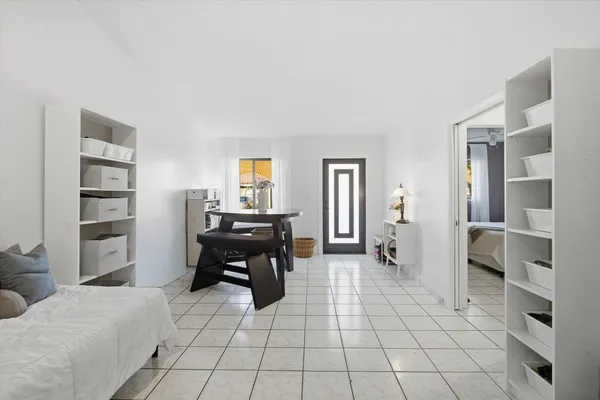 a bedroom with furniture and a book shelf