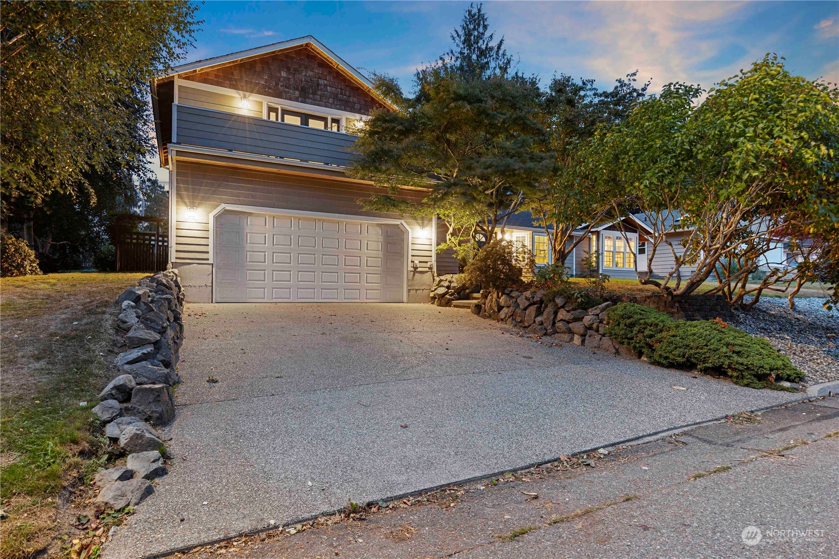 a front view of a house with a yard and garage