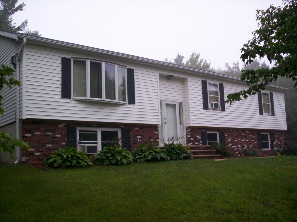 a front view of a house with a garden