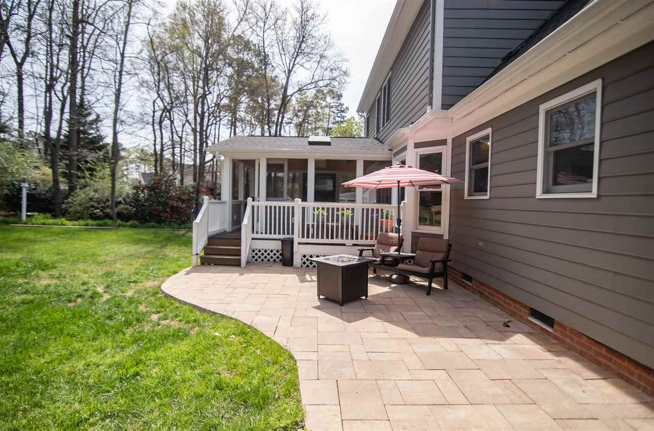 9116 Dawnshire Road Raleigh, NC 27615 - Photo 29 of 30 Your backyard oasis awaits! Fully fenced, a screened in porch, and lovely stone patio. Backyard