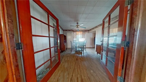 a hallway with wooden floor and furniture