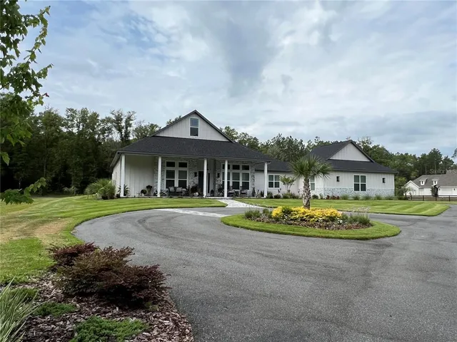 a front view of a house with a yard table and chairs