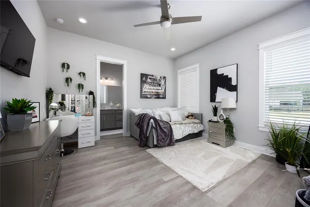a bathroom with a granite countertop sink toilet a mirror a vanity and shower
