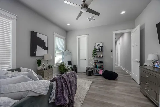 a bed room with a bed and a painting on the wall