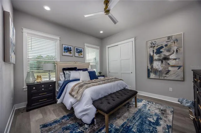 a bathroom with a granite countertop sink a toilet a shower and a mirror