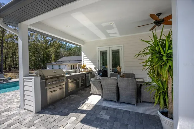 a view of a house with pool and a yard