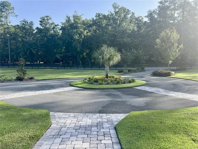 a living room with furniture a dining table and a large window