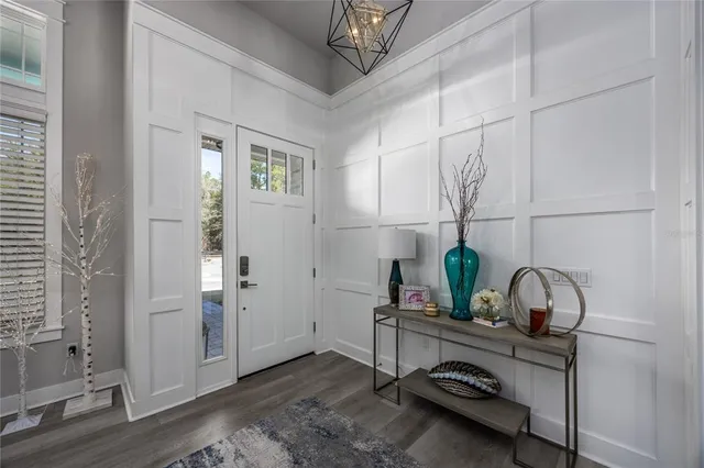 a view of a dining room with furniture and chandelier